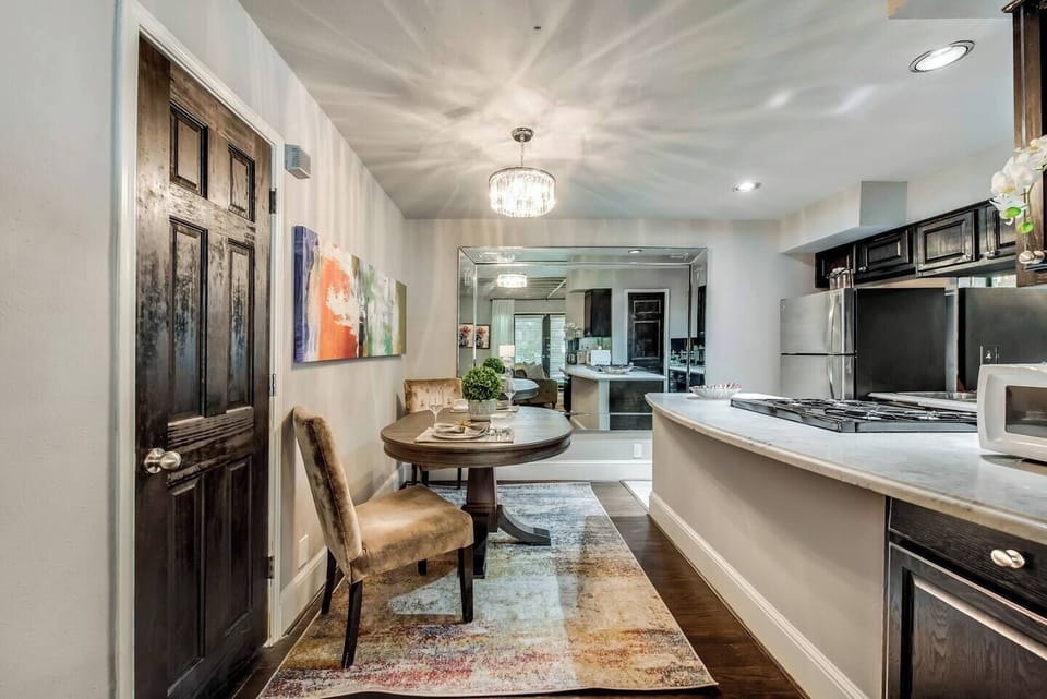 The modern dining room is the perfect spot to enjoy your morning coffee or savor a gourmet meal in style.