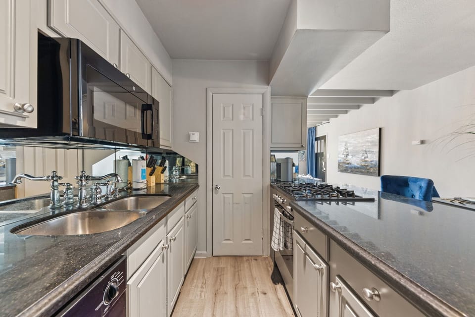 The kitchen is fully equipped with everything you need to prepare meals, featuring modern appliances and plenty of counter space for your convenience.