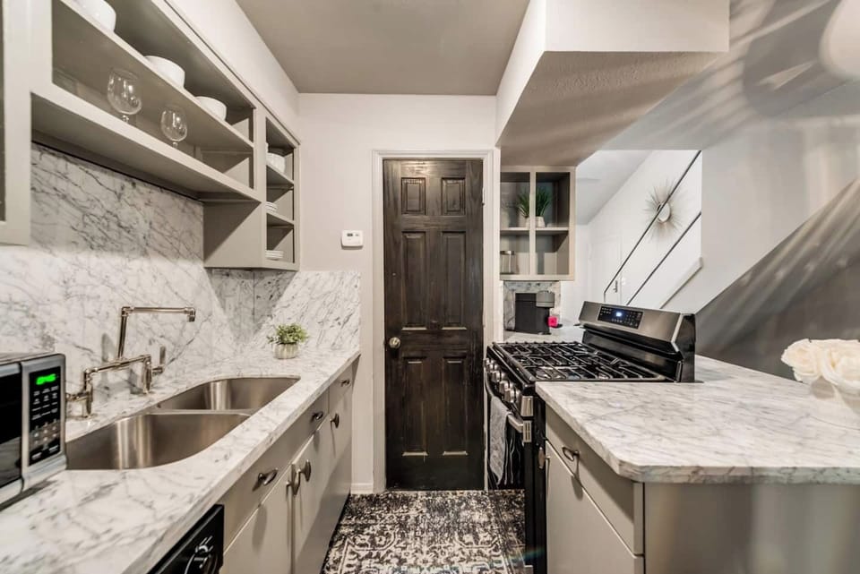 Kitchen with gas range, Nespresso machine, microwave and all appliances/kitchen essentials.