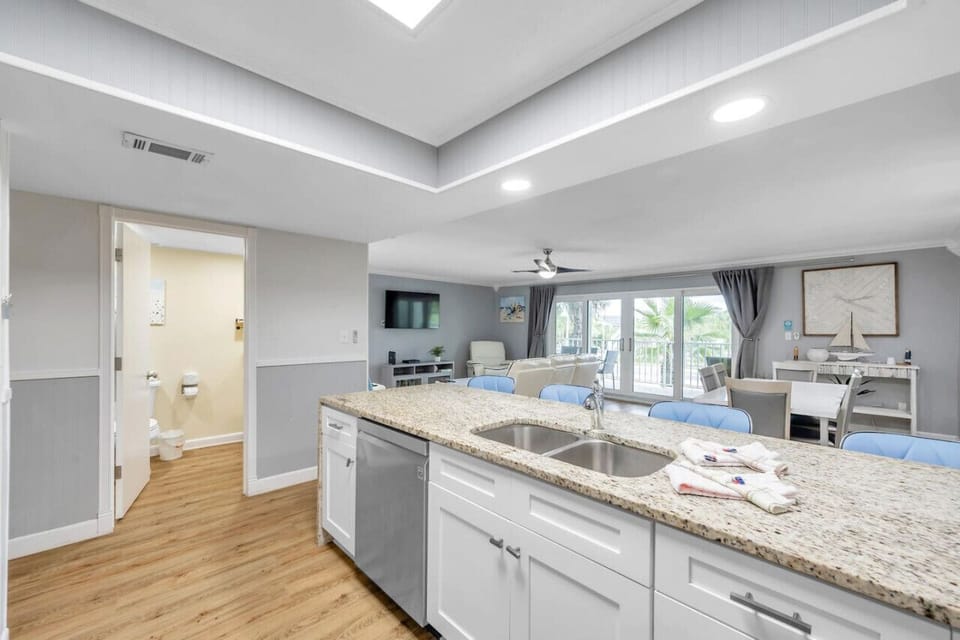 Bright kitchen view w/ generous counter space & nearby hallway access.
