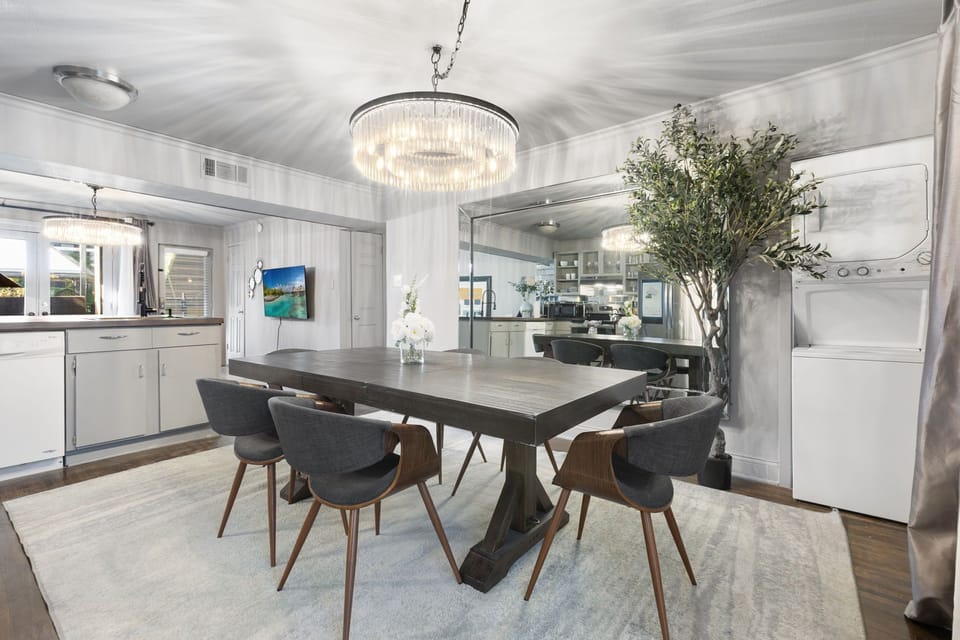 Mirror-accented dining room with greenery for a spacious feel