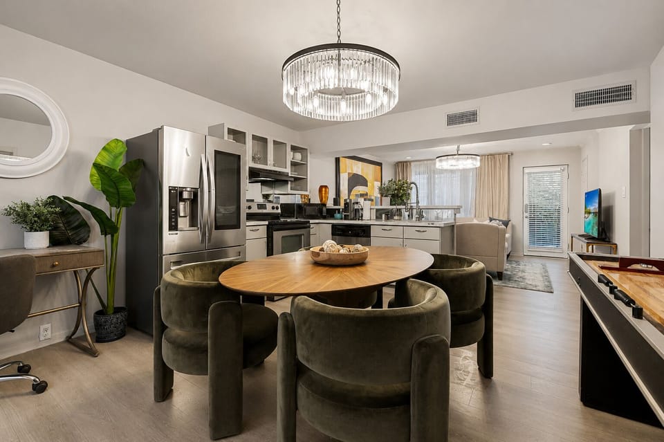 Cozy dining space with velvet seating and modern chandelier lighting