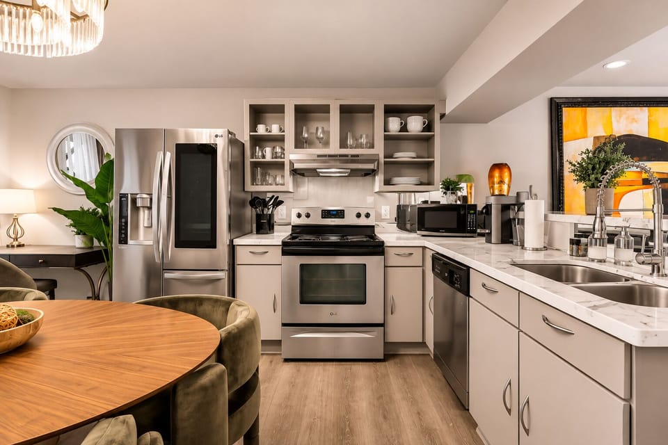 Fully equipped kitchen with stainless steel appliances and premium cookware