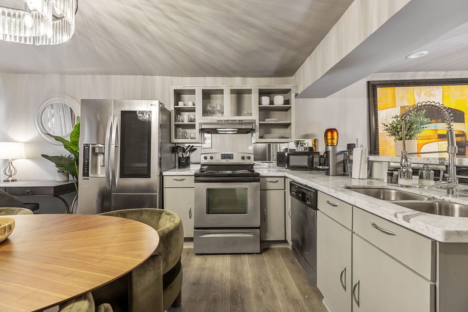 Fully equipped kitchen with stainless steel appliances and premium cookware
