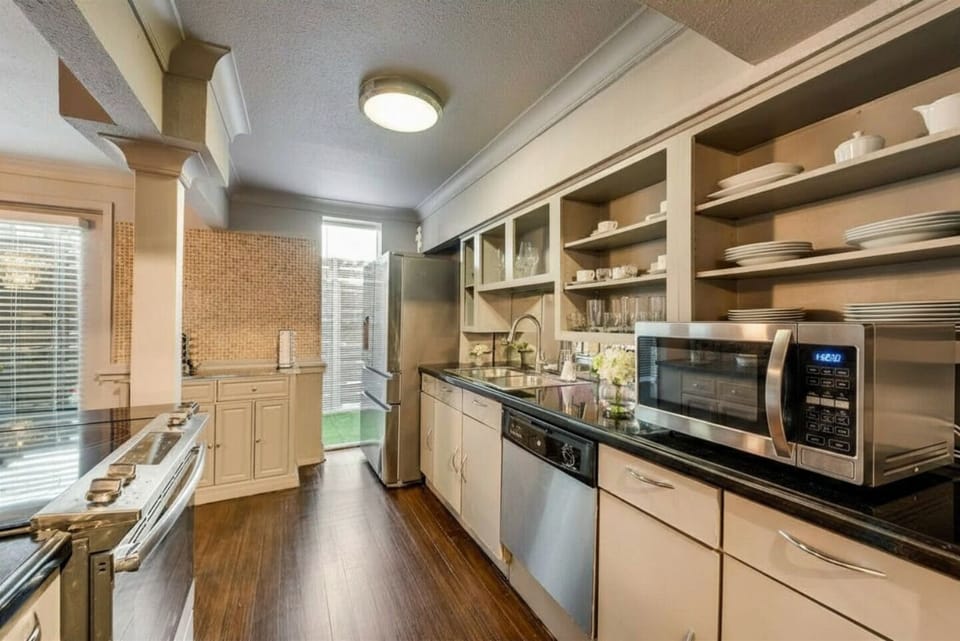 Fully equipped kitchen with modern stainless steel appliances, perfect for preparing meals with ease.