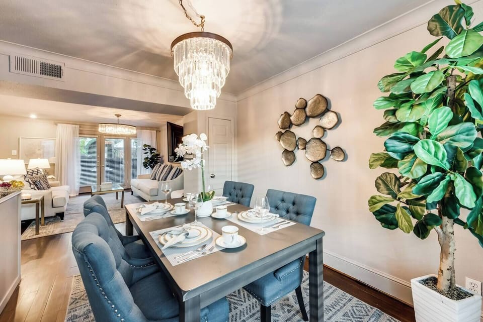 Open dining area with seating for four, featuring a beautiful chandelier.