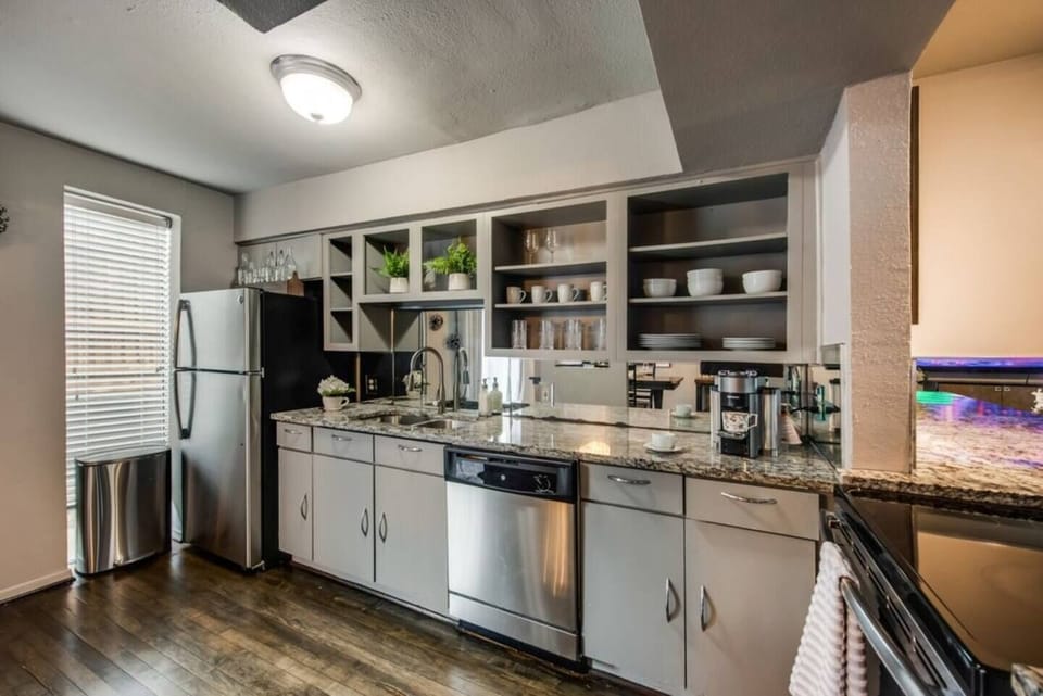 The kitchen is generously sized and boasts sleek, contemporary appliances, fully outfitted to meet all your cooking and dining needs.
