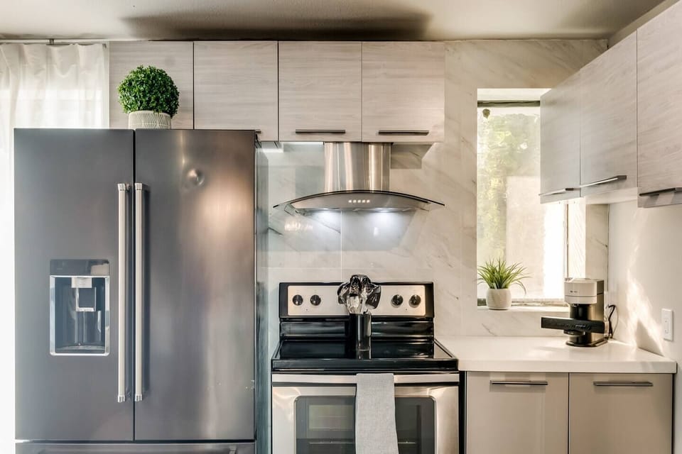 Spacious kitchen with sleek, modern appliances, fully equipped for all your cooking and dining needs with an extra large fridge. 
