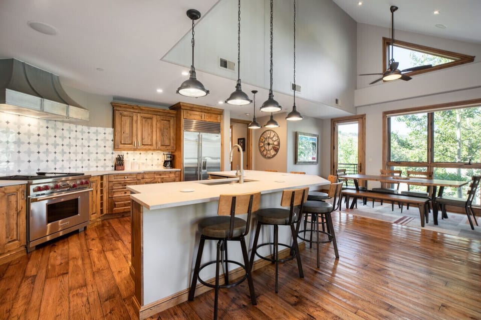 Modern fully stocked kitchen with plenty of counter space & barstools