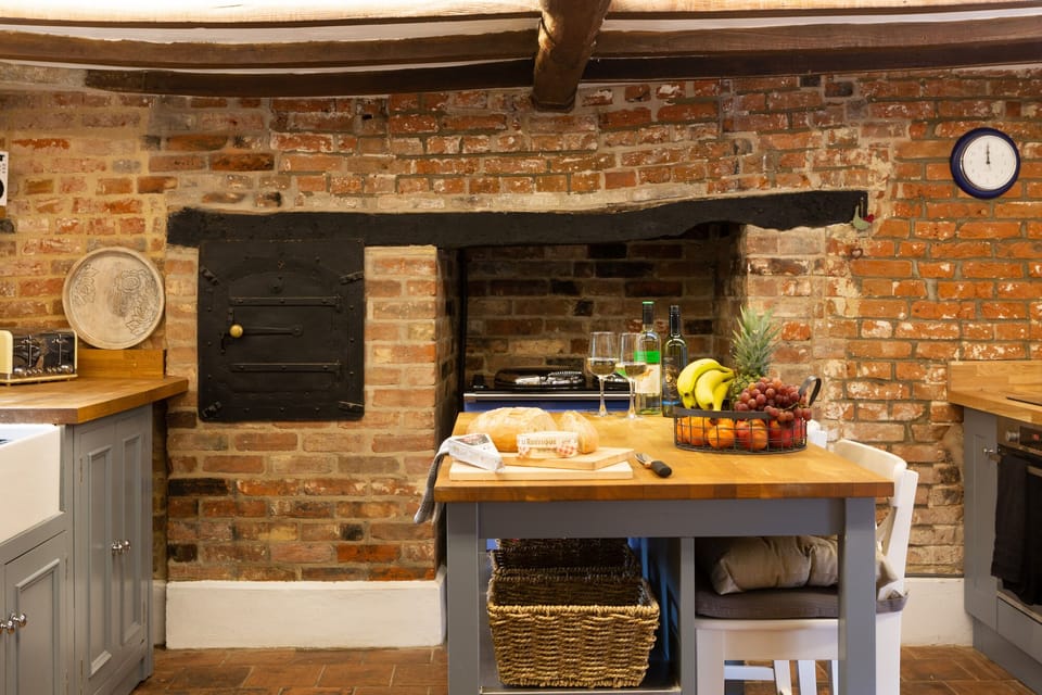 The cottage kitchen has attractive exposed brickwork