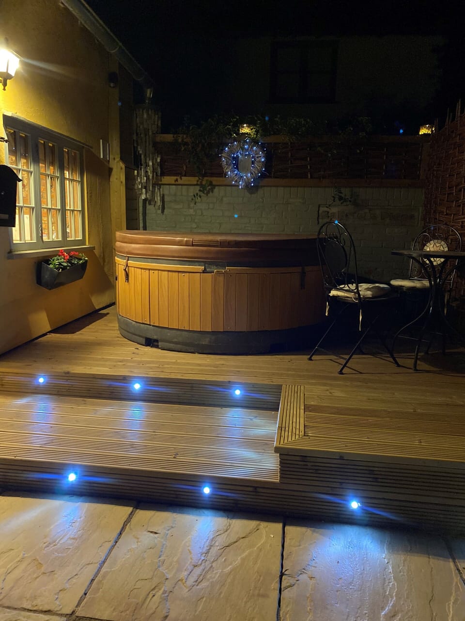 The hot tub lit up before the wooden pergola was built.