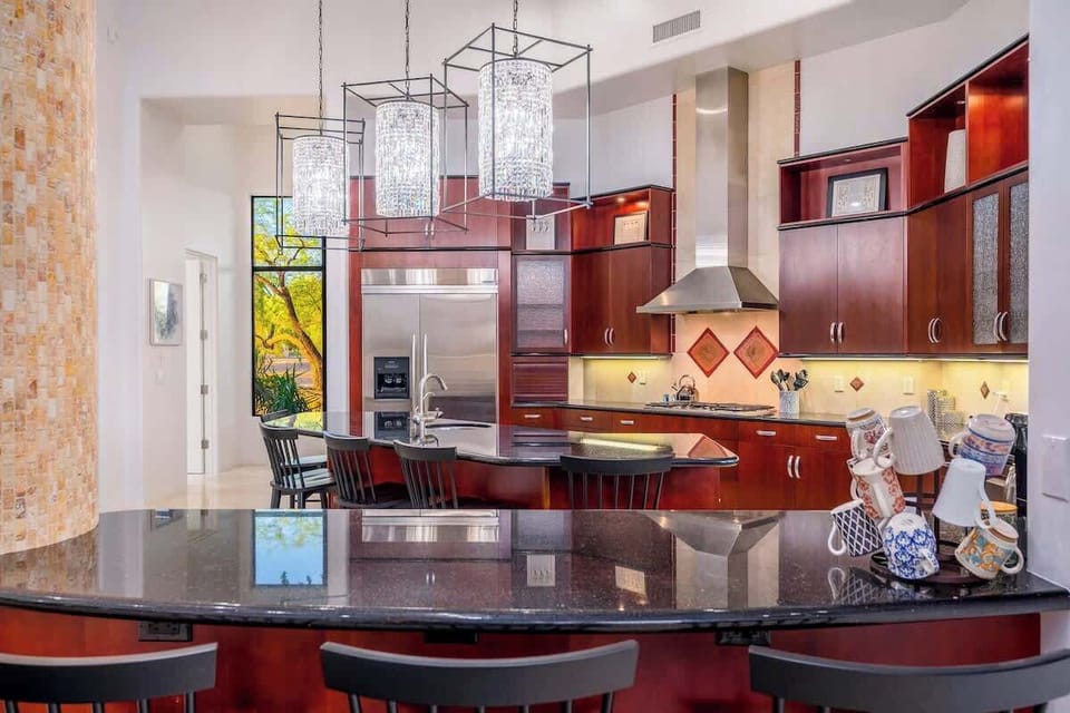 Your gourmet kitchen awaits with rich wood cabinetry, gleaming granite counters, stainless appliances, and a stunning island—perfect for cooking and gathering with loved ones.