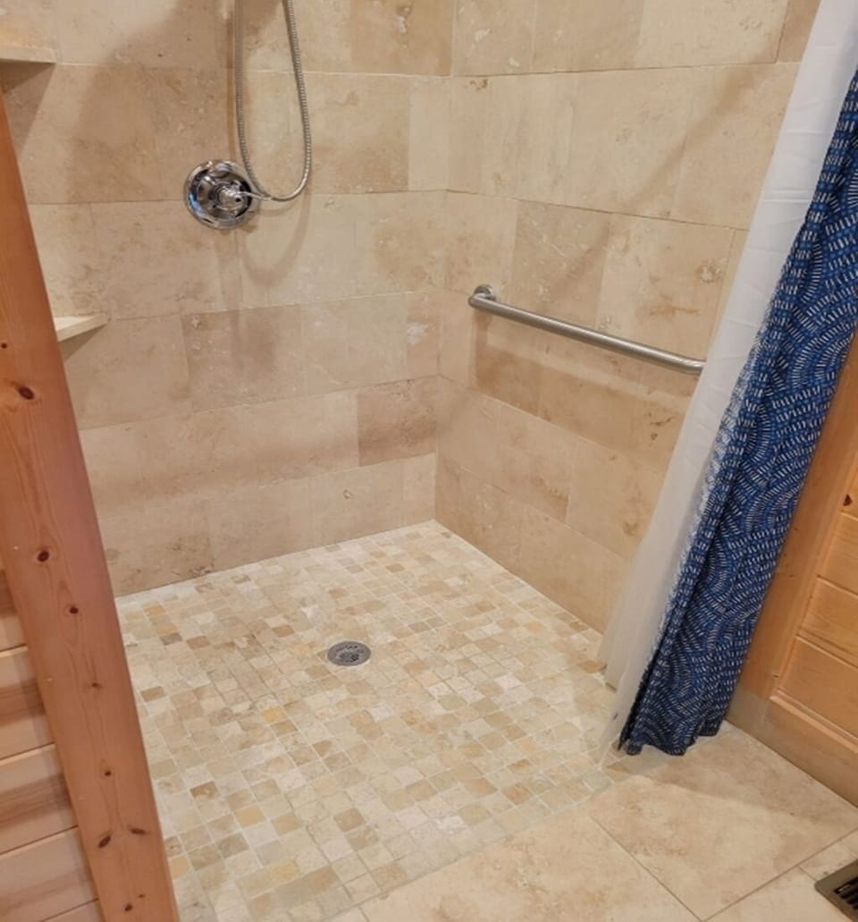 Handicapped Shower with smooth entry and rail. In First Floor Master.