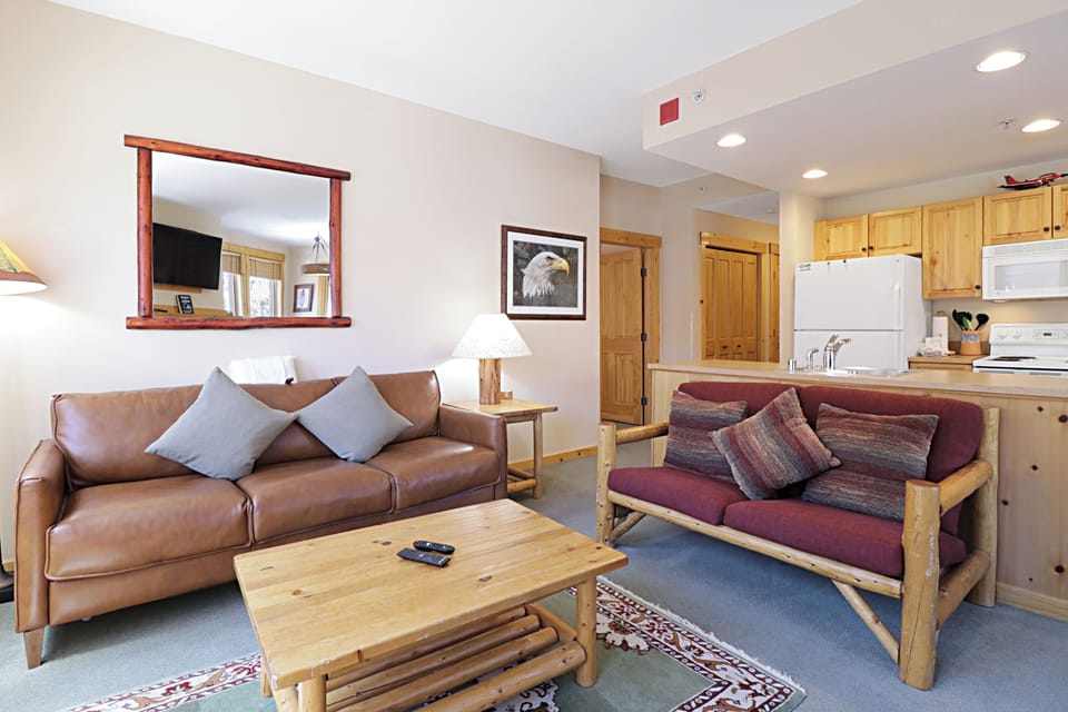 Relax in your cozy living space with leather seating and rustic mountain charm flowing into a fully equipped kitchen.