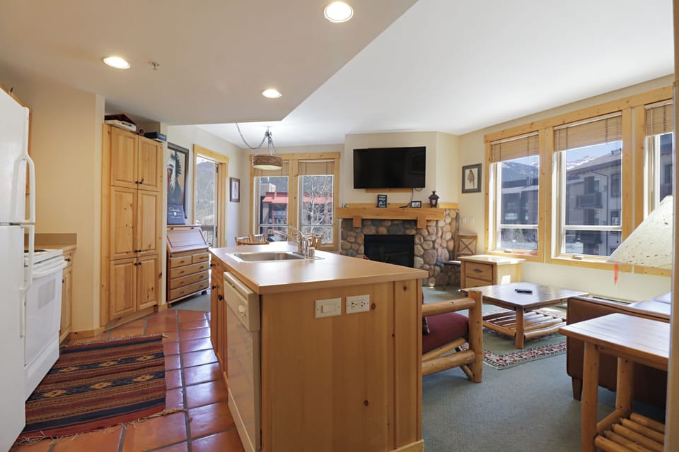 Gather around your spacious kitchen island where warm wood tones and mountain views create the perfect backdrop for memorable meals together.
