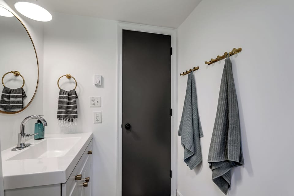 This full bathroom has a toiletries and plenty of hooks to hang your stuff!