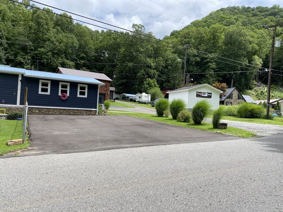 Driveway paved and fenced in front yard 