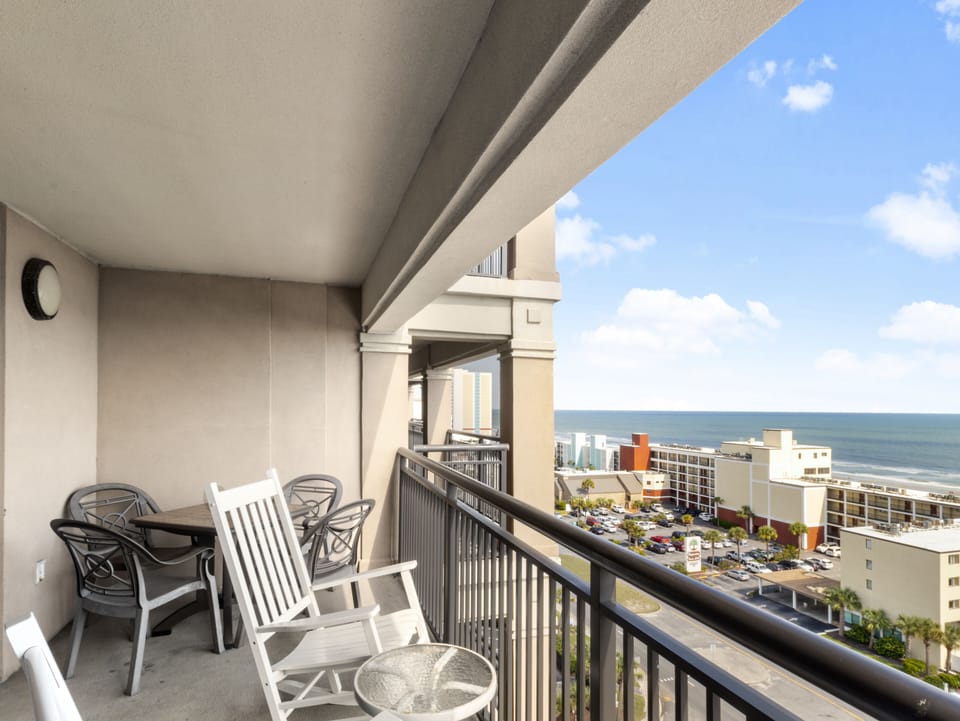 Unwind on your private balcony with ocean views, perfect for morning coffee or evening relaxation with comfortable seating.
