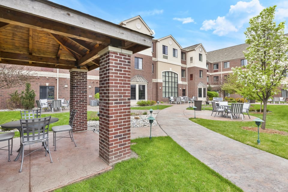 Enjoy the tranquility of the outdoor space with comfortable seating and well-kept greenery surrounding you.