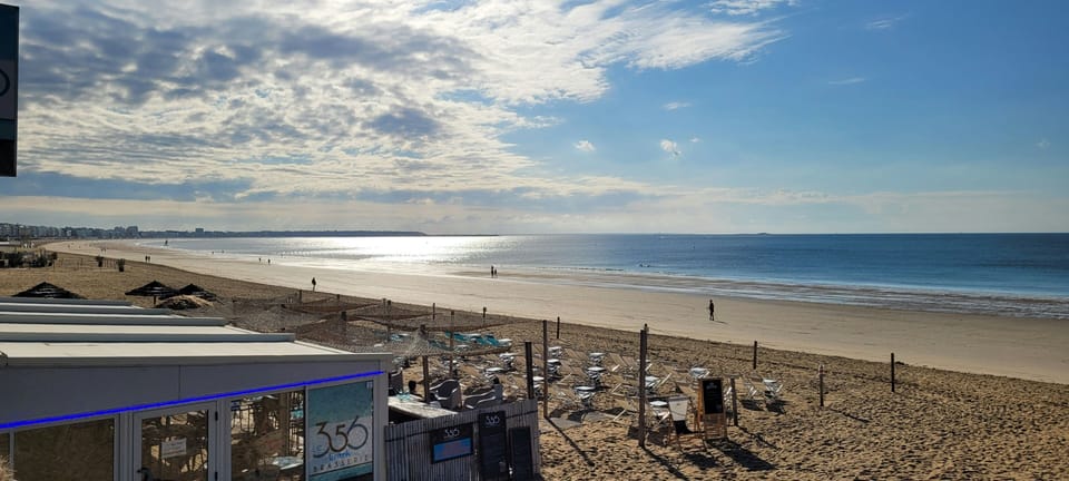Sun-drenched shores, laughter dances in the breeze