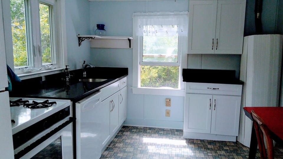 Kitchen with full sized frig, stove, microwave, coffee makers, granite counters