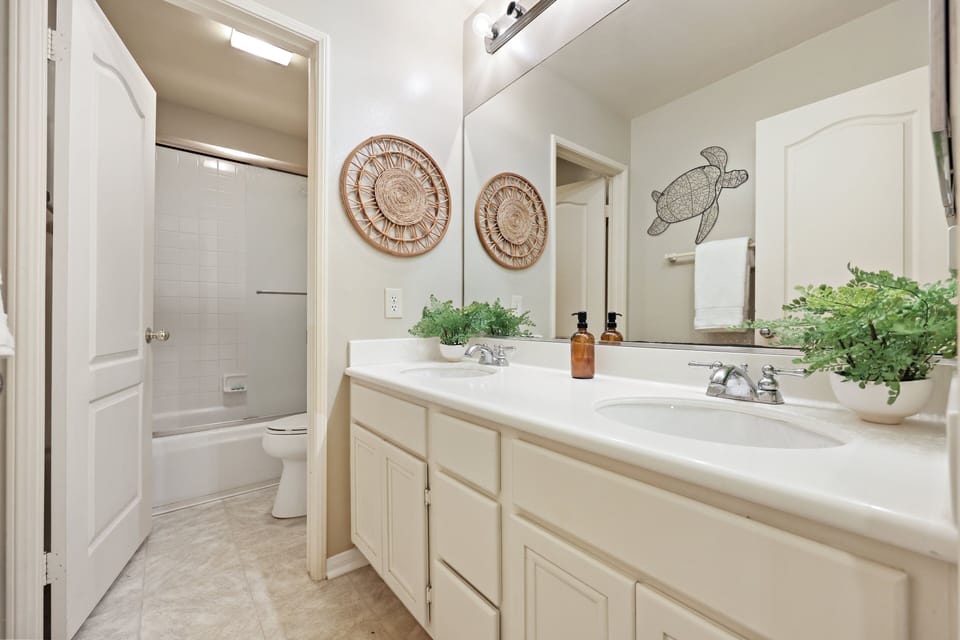 Upstairs hall full bathroom with plenty of counter space and tub/shower combo.