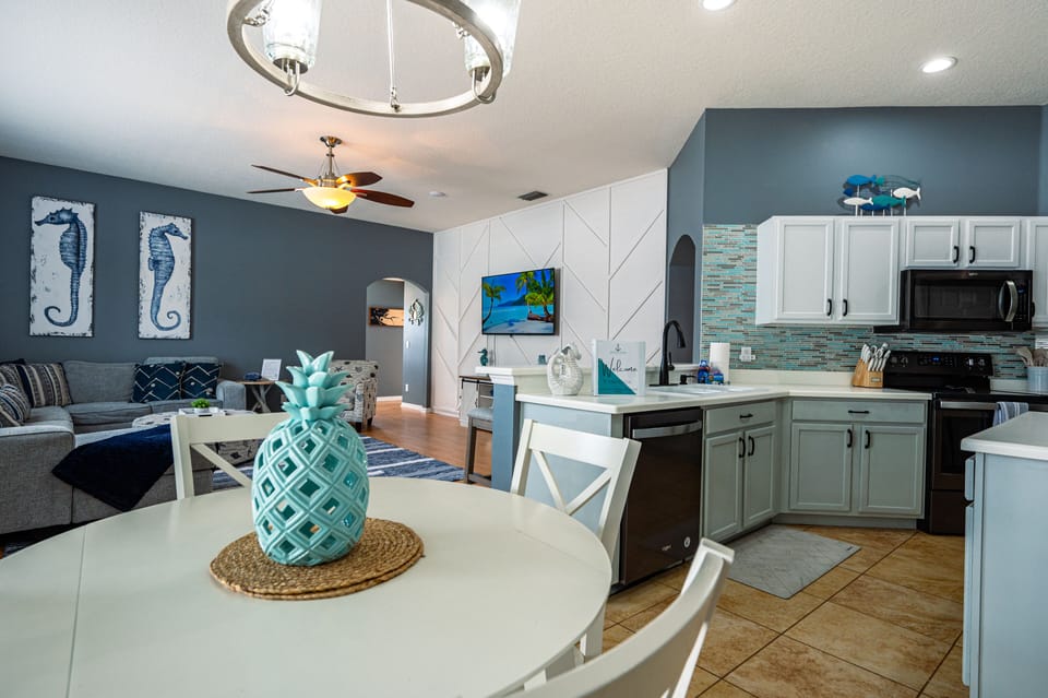 Cook together in a kitchen designed to feel like a vacation — plenty of counter space, teal accents, and everything you need