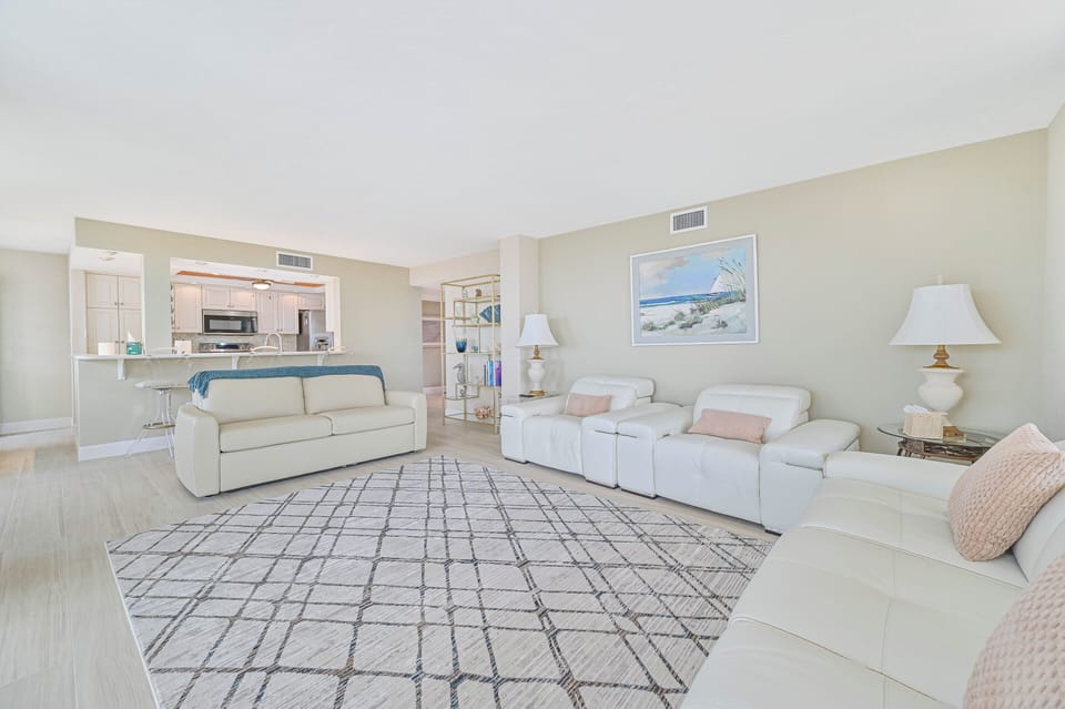 VSC801 - Comfortable seating and flat screen TV in the living. Sliding doors open up to the corner balcony with Gulf view