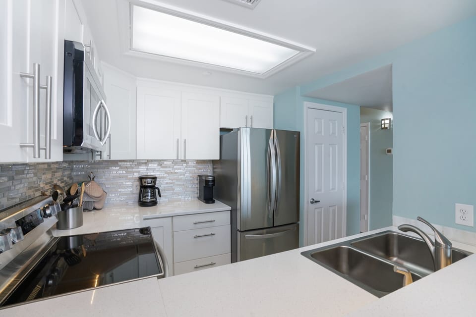 Step into your fully equipped kitchen with sparkling white cabinets, granite counters, and stainless steel appliances ready for memorable meals together.