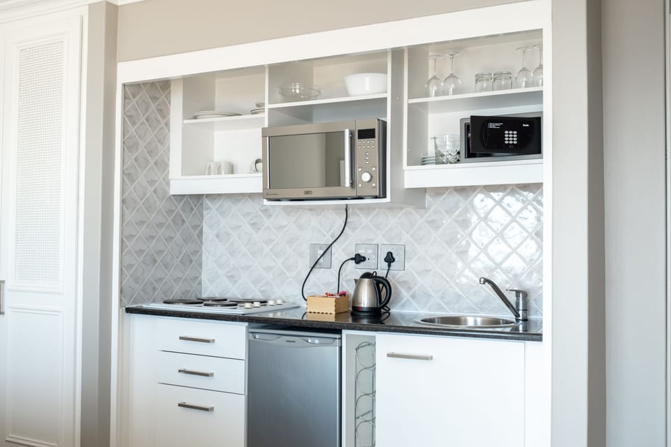 Fridge, coffee/tea maker, electric kettle, cookware/dishes/utensils