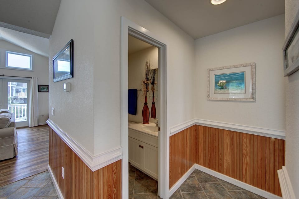Hall/ powder room - Located just off the kitchen this powder room is convenient and functional.