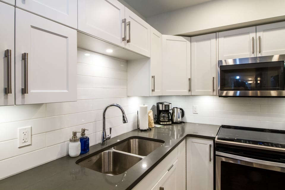 Magog Condo | Private kitchen | Coffee/tea maker, full-size fridge, microwave, oven