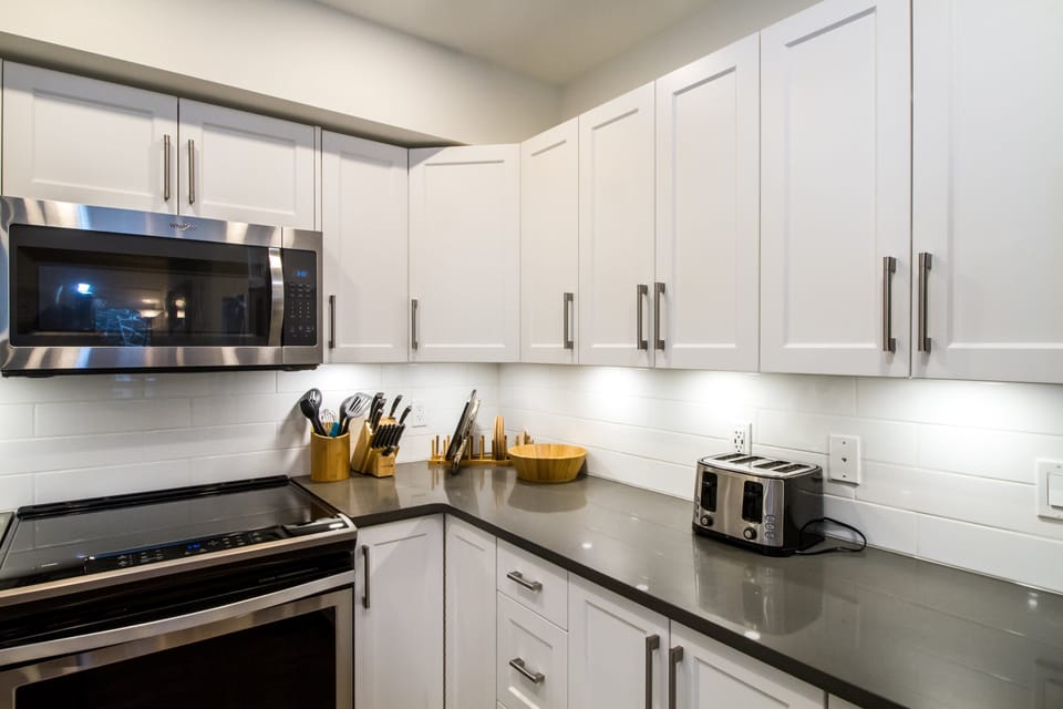 Magog Condo | Private kitchen | Coffee/tea maker, full-size fridge, microwave, oven