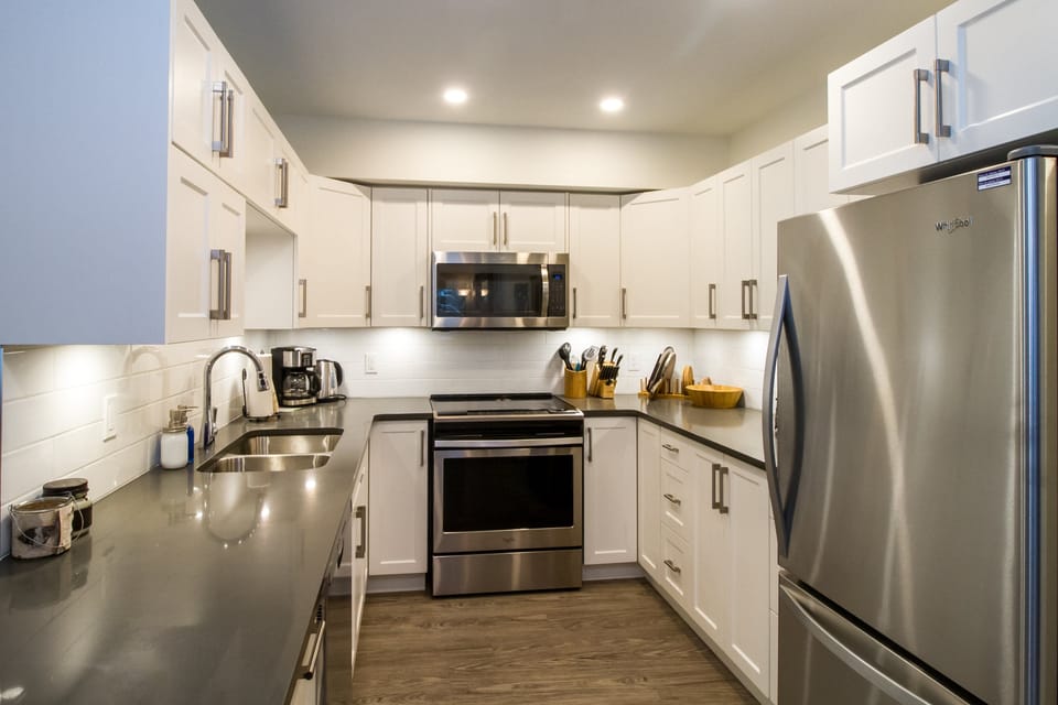 Magog Condo | Private kitchen | Coffee/tea maker, full-size fridge, microwave, oven