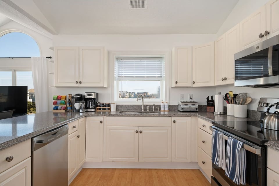 Cook up a storm with a seaside serenade in this sunlit kitchen haven.