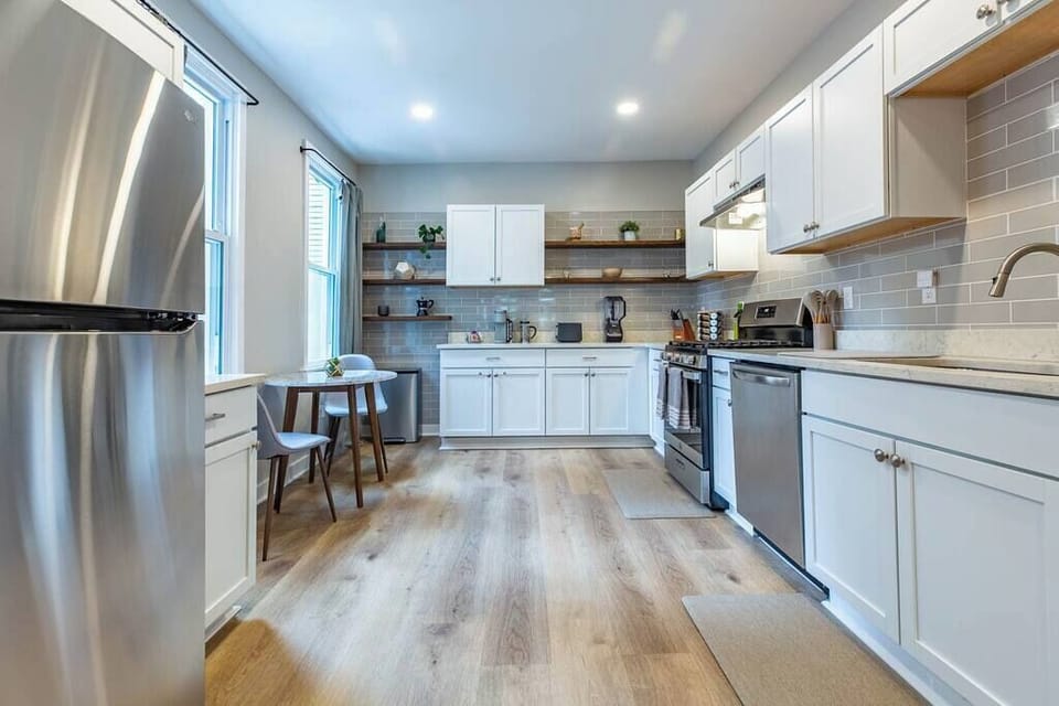 Step into our spacious kitchen, complete with a convenient fridge and a cozy round table for two.