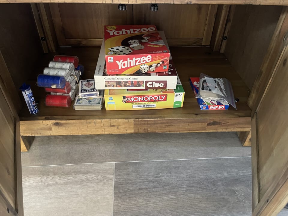 Games in cabinet under dining table