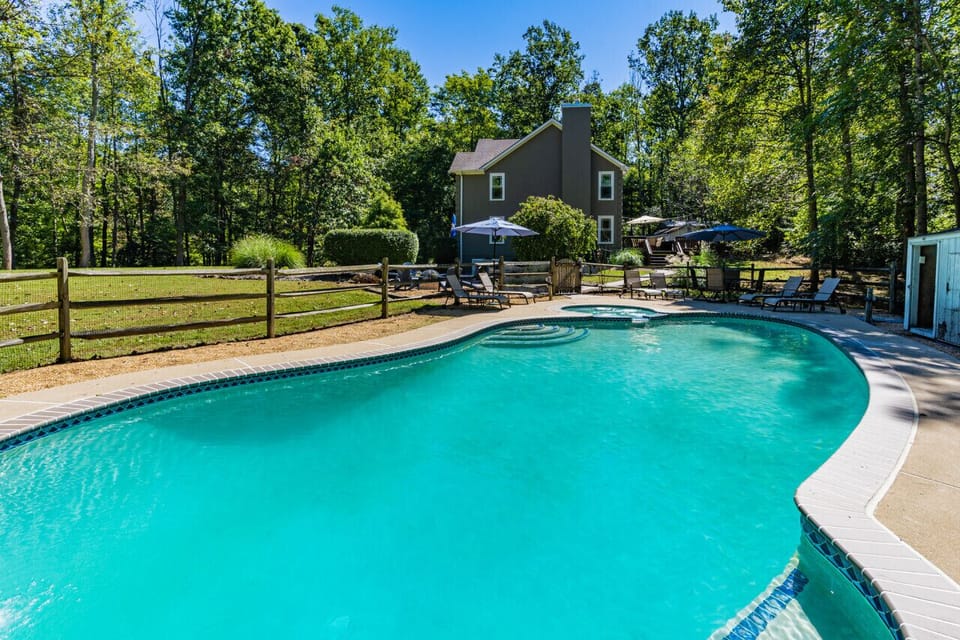 Welcome to this DC Retreat! A 5BR home with large, heated pool sitting on 8 wooded acres close to wineries, hiking, and history
