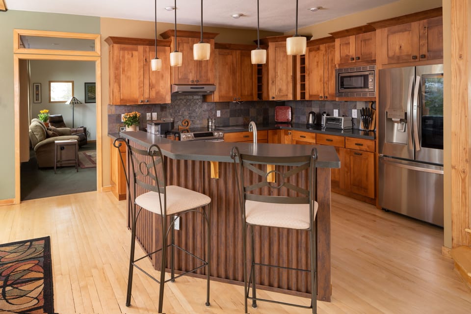 A kitchen with wooden cabinets and counter tops.
