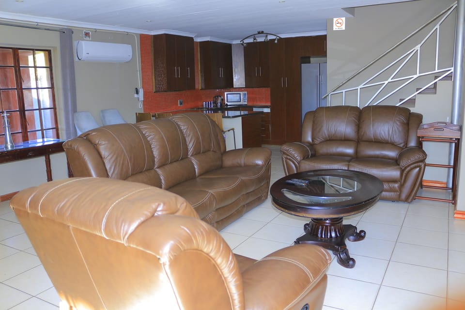 Executive Suite, Patio | Living area | 75-cm plasma TV with satellite channels