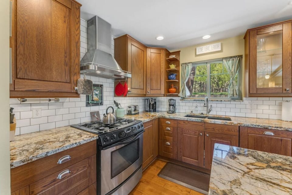 The kitchen is fit with plenty of bright lighting and granite countertops.