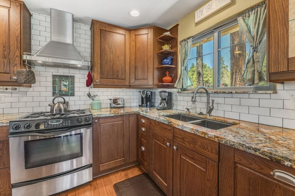 A stainless steel gas range and oven paired with spacious granite countertops make creating your favorite meals away from home easy.