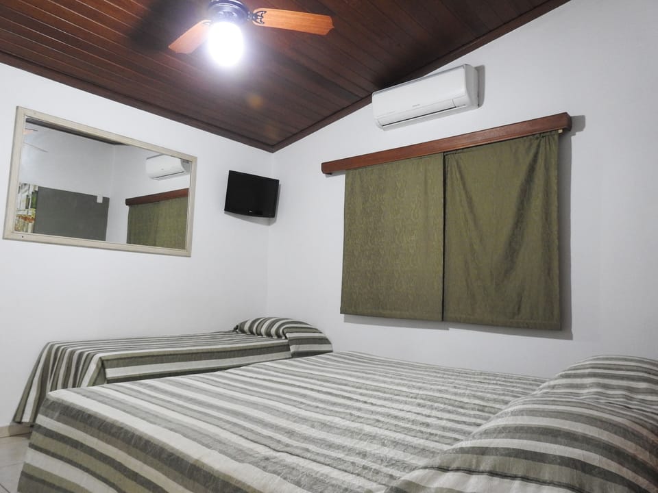 Economy Triple Room | Minibar, in-room safe, bed sheets