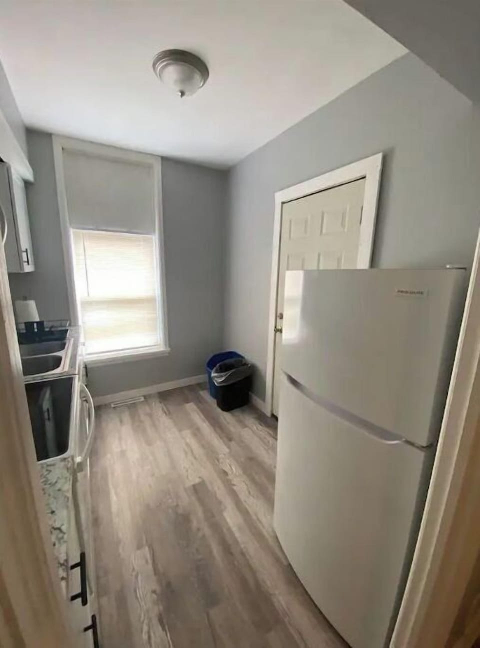 Kitchen with microwave, full size fridge, stove, toaster and Keurig coffee maker