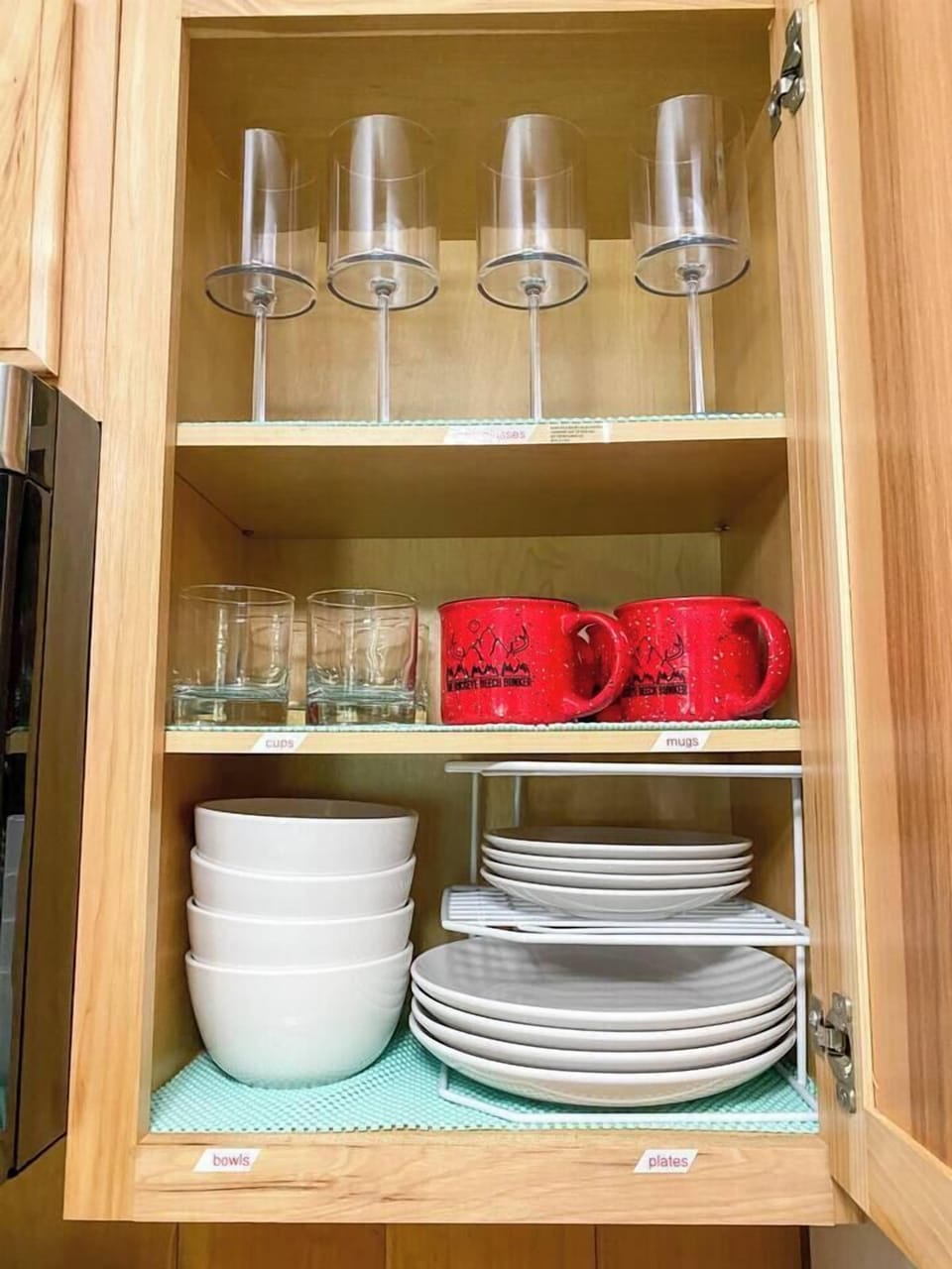 Kitchen fully stocked with cookware, cups, dishes, and coffee mugs.