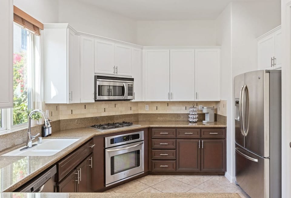 White cabinets and stainless appliances give you a clean workspace for meal prep.