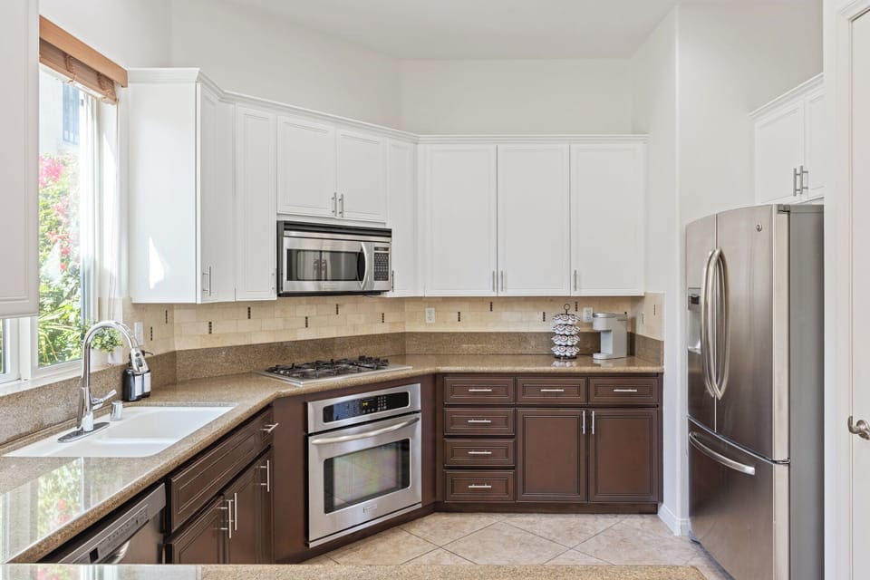 White cabinets and stainless appliances give you a clean workspace for meal prep.