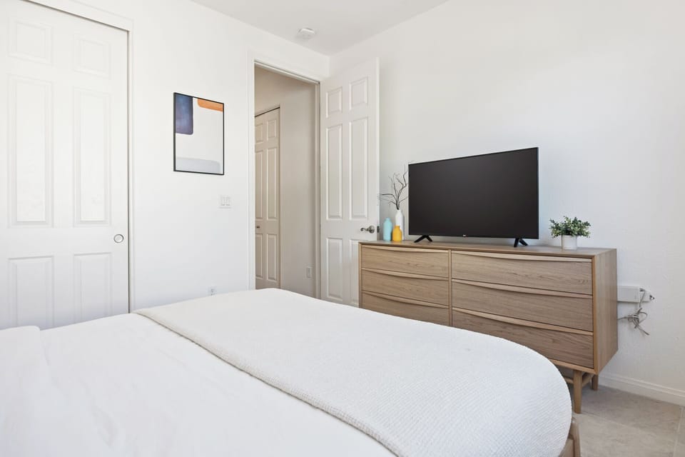 Simple and bright second bedroom gives everyone their own comfortable sleeping space.