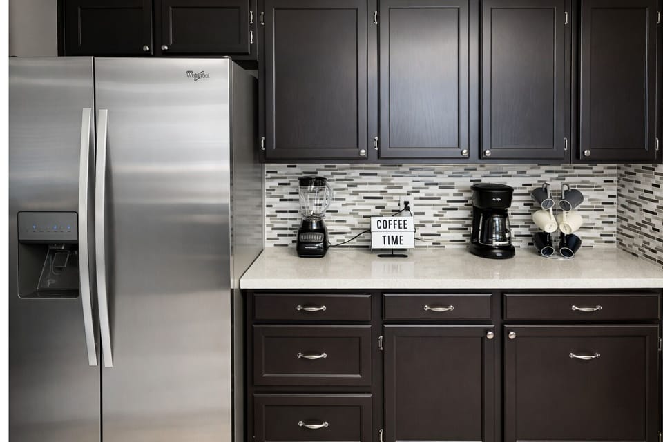 Modern kitchen with stainless fridge and a ready-to-brew coffee bar