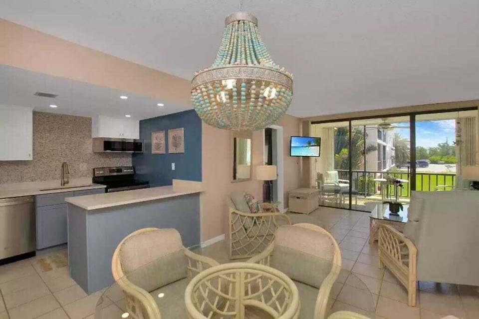 Dine and unwind in elegance with our sparkling chandelier, sleek furnishings, and a direct view of lush outdoors, blending comfort with style.